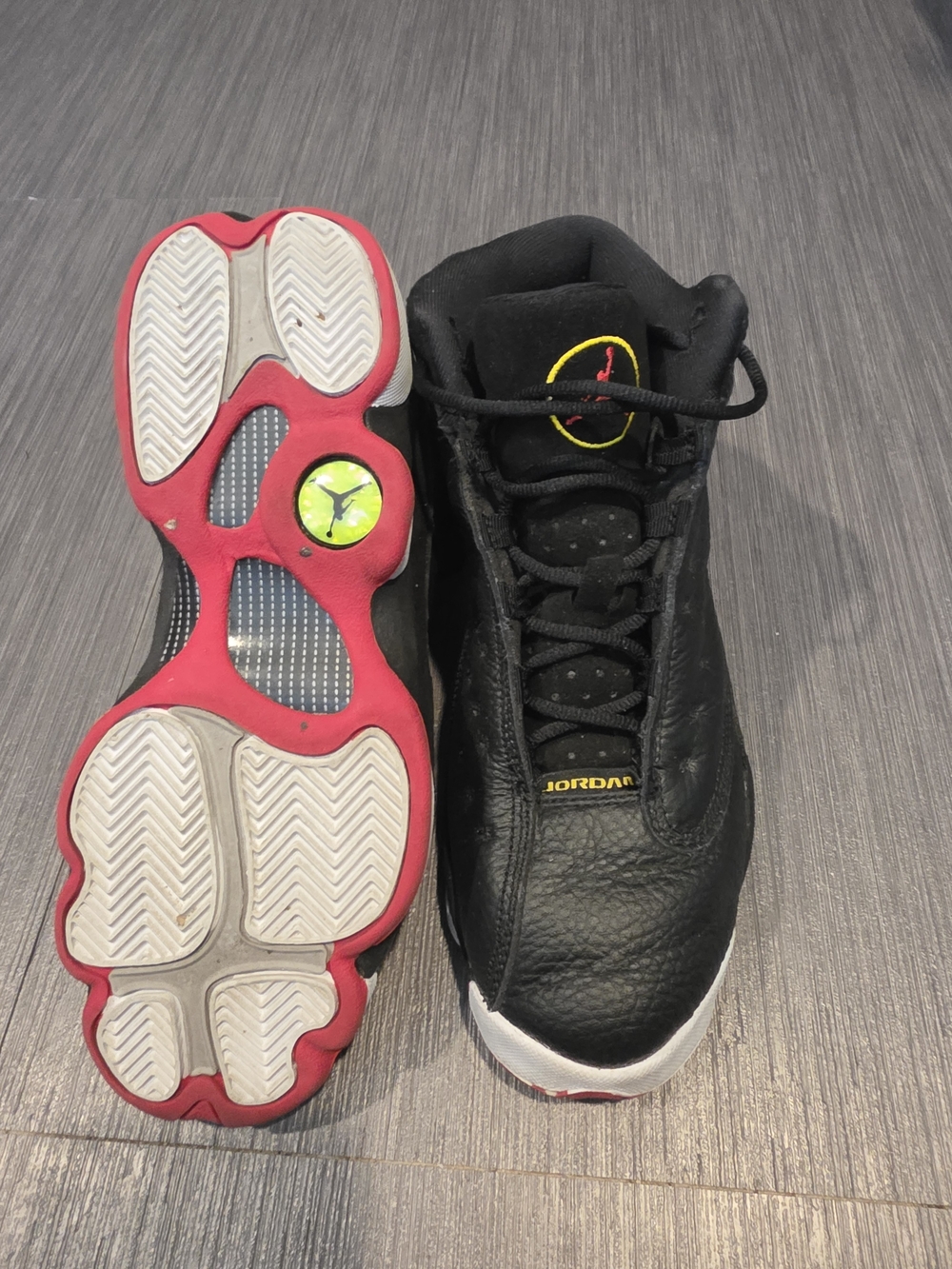 Jordan Youth’s Black Basketball Sneakers with Red Outsole and Yellow Accents